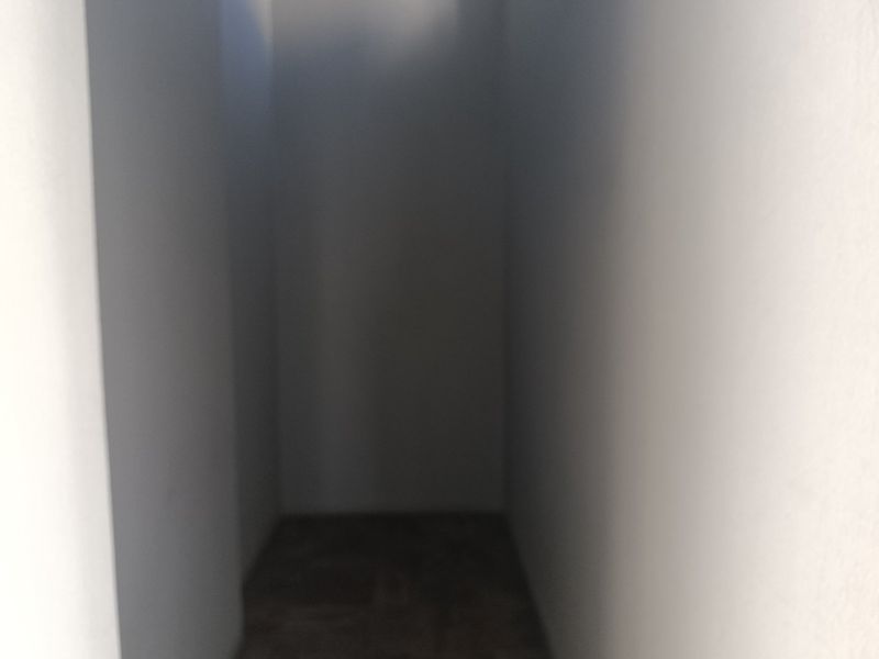 A poorly lit and blurry interior space, likely a small storage area or closet, with insufficient detail for assessment.