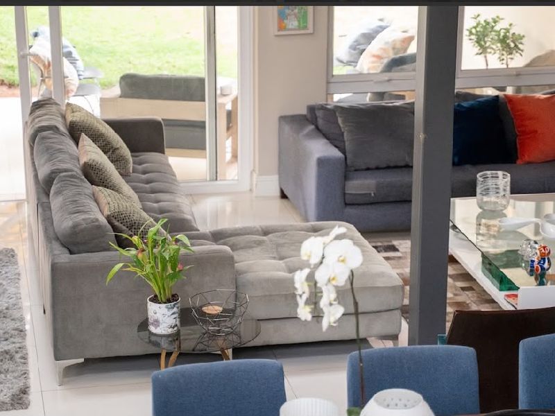 Spacious open-plan living area featuring large sliding glass doors that provide seamless access to the outdoor patio and garden.