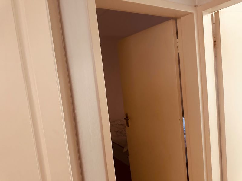 A view of a hallway showing multiple internal doors and frames leading into adjacent rooms.