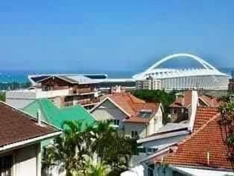 Elevated view overlooking the surrounding residential neighborhood with the stadium and ocean visible in the distance.