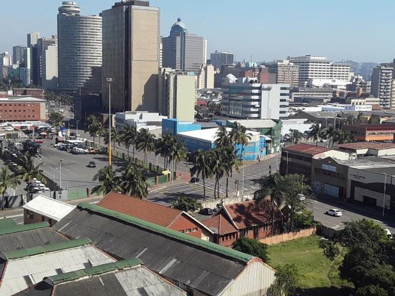 An elevated urban cityscape view showcasing surrounding buildings, streets, and infrastructure in a metropolitan area.