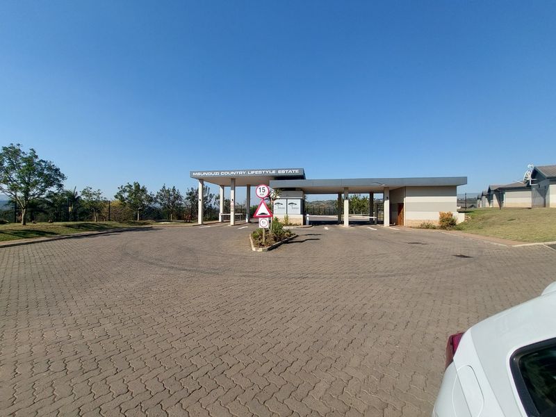 The main entrance and security gatehouse of the Msunduzi Country Lifestyle Estate, featuring paved access and controlled entry points.
