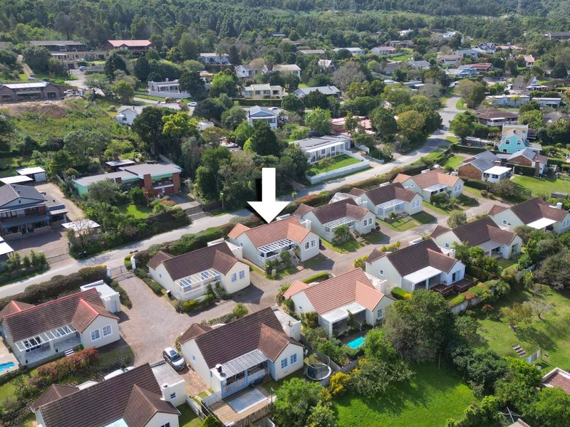 Aerial view of a residential property within a suburban estate, highlighting the house location, roof structure, and surrounding neighborhood layout.