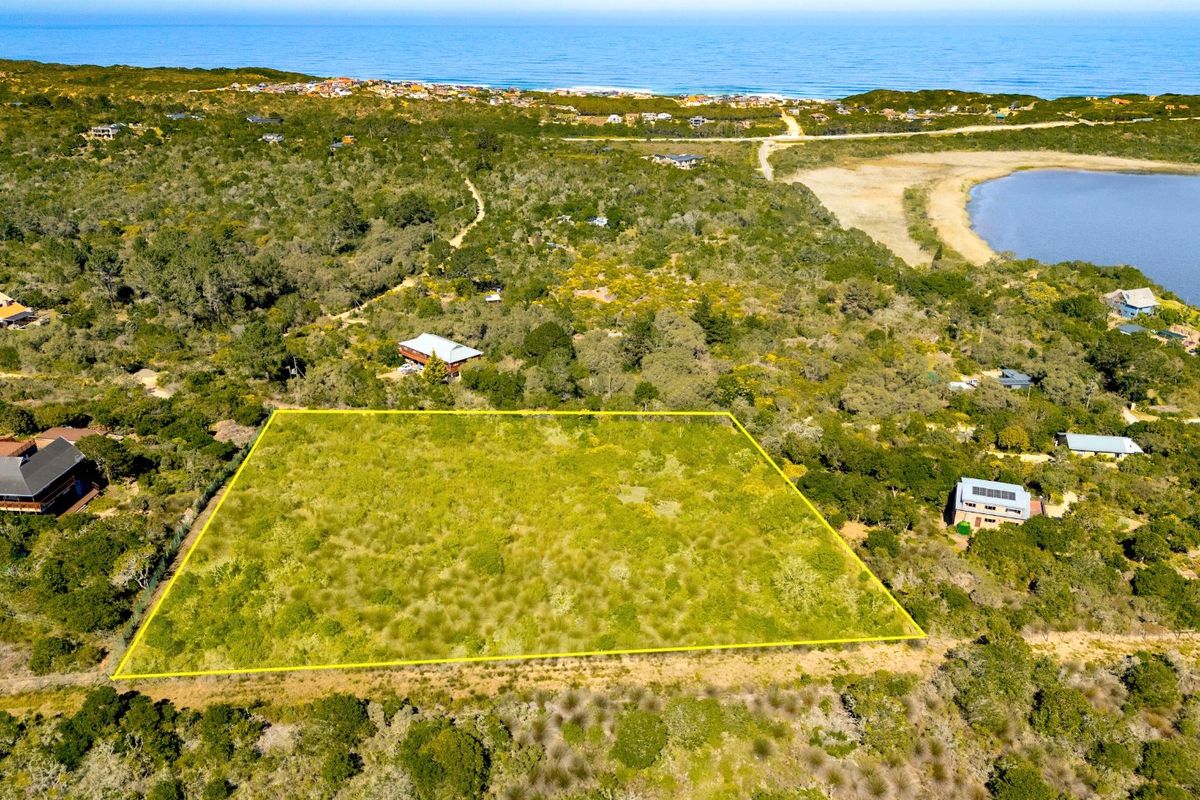 Aerial view of a vacant residential plot surrounded by coastal vegetation, offering proximity to the ocean and local landscape.