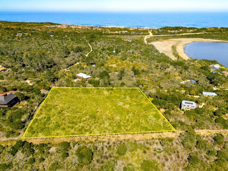 Aerial view of a vacant residential plot surrounded by coastal vegetation, offering proximity to the ocean and local landscape.