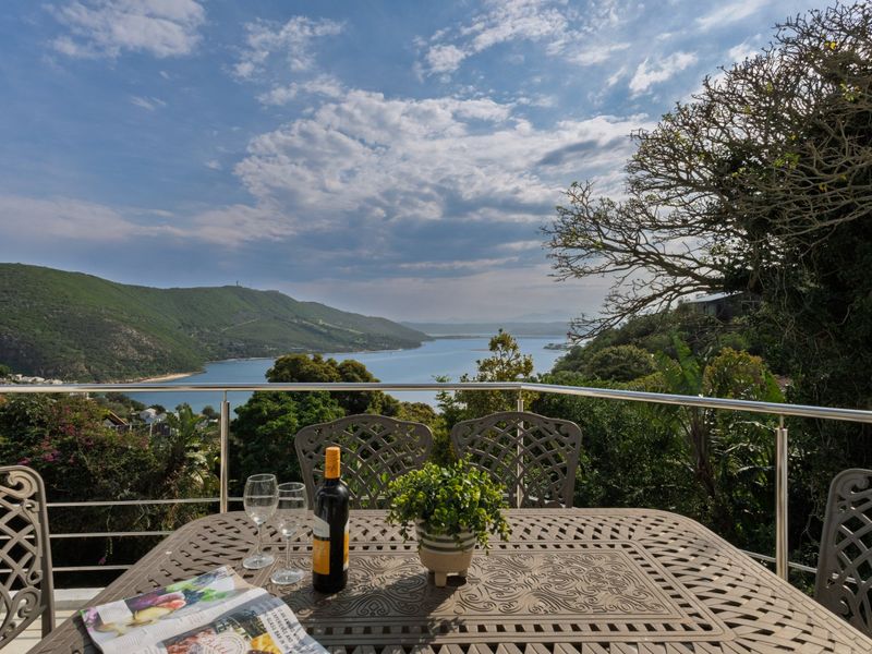 A scenic balcony featuring a stainless steel balustrade, offering expansive views of the surrounding landscape and water.