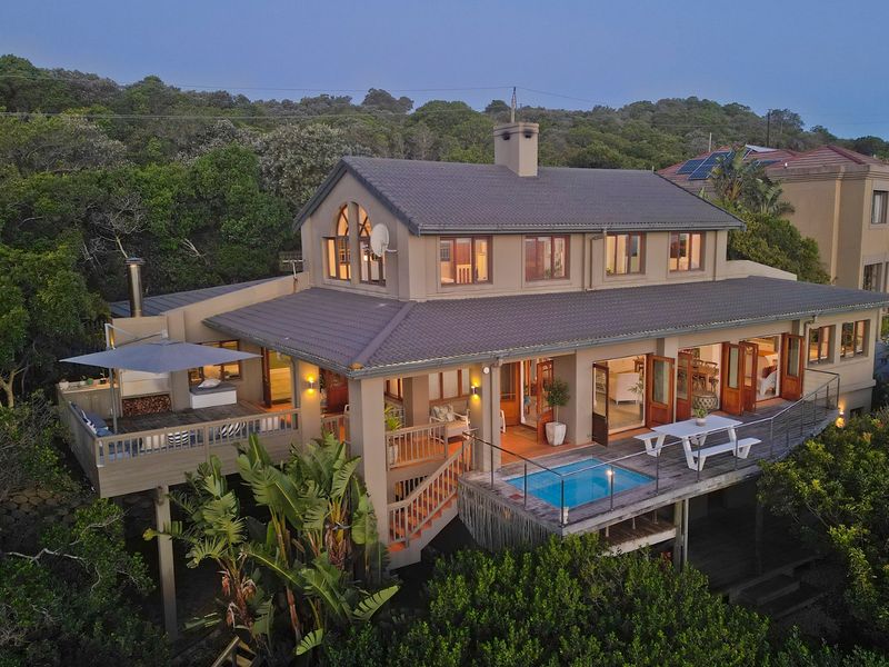 Aerial view of the rear elevation featuring a multi-level timber deck, a plunge pool, and direct access to the interior living spaces.