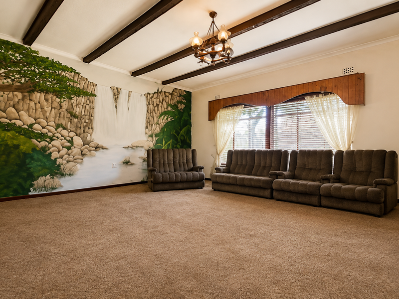 Spacious living room featuring exposed timber ceiling beams, a decorative chandelier, and a large wall mural, offering a dated but well-maintained interior space.