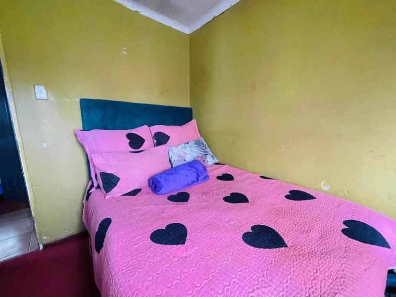 A bedroom featuring yellow painted walls and carpeted flooring, requiring cosmetic updates to improve the overall aesthetic and condition of the space.