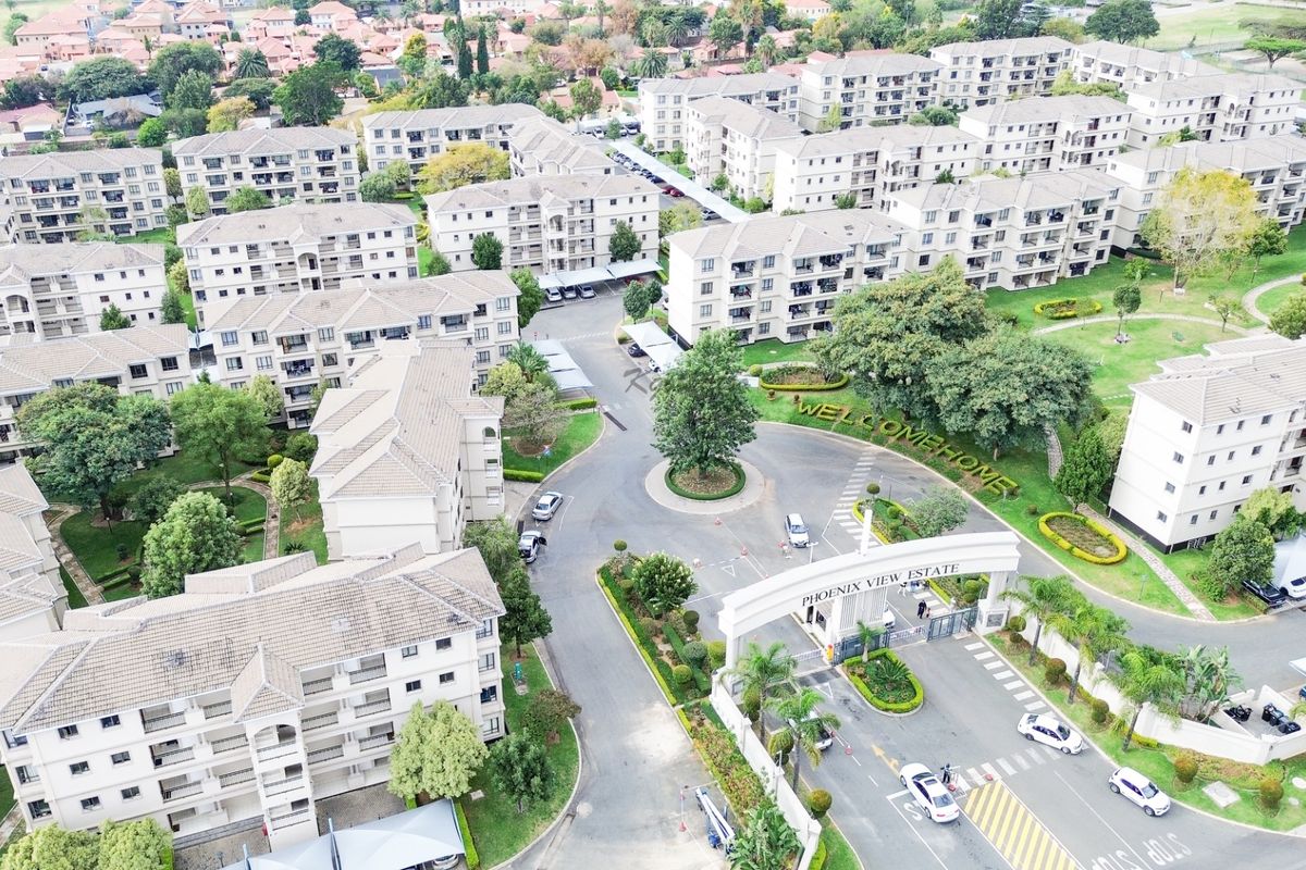 Aerial view of Phoenix View Estate, showcasing the gated entrance, landscaped grounds, and multiple residential apartment blocks within the complex.