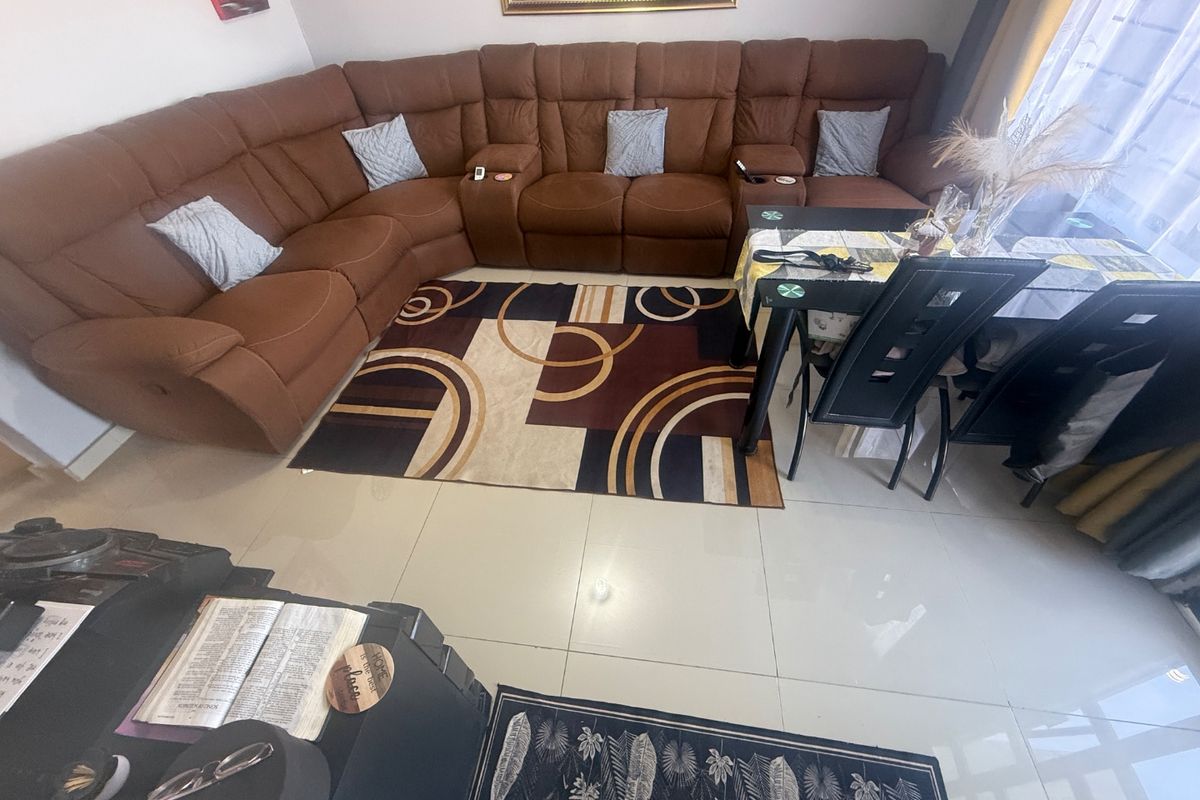 A spacious living area featuring polished tiled flooring, providing a neutral foundation for the room's layout.