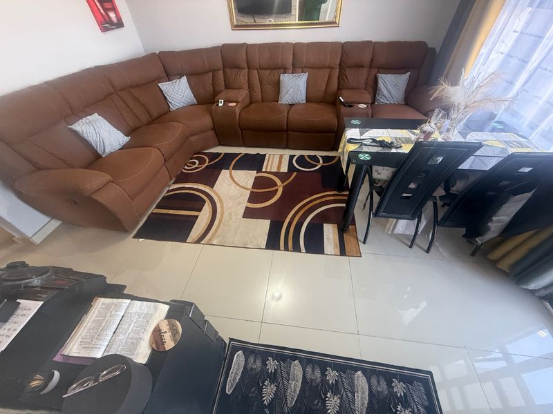 A spacious living area featuring polished tiled flooring, providing a neutral foundation for the room's layout.