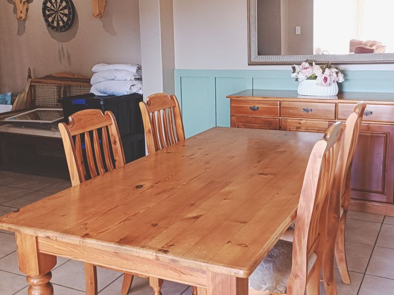 A dining room featuring tiled flooring and decorative wainscoting on the walls, providing a functional space for family meals.
