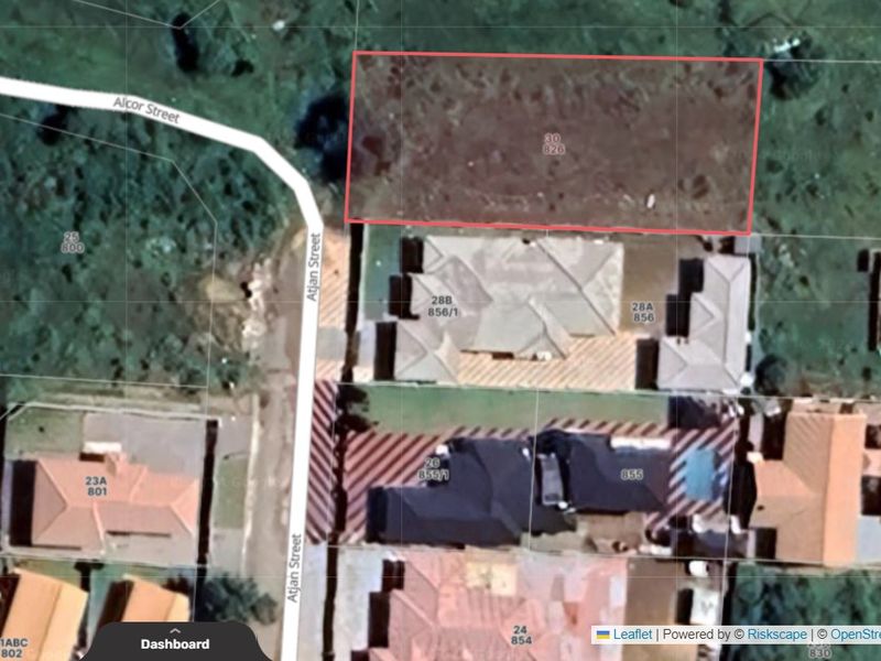 An aerial view showing the vacant residential land plot outlined in red, situated within a developed neighborhood setting.