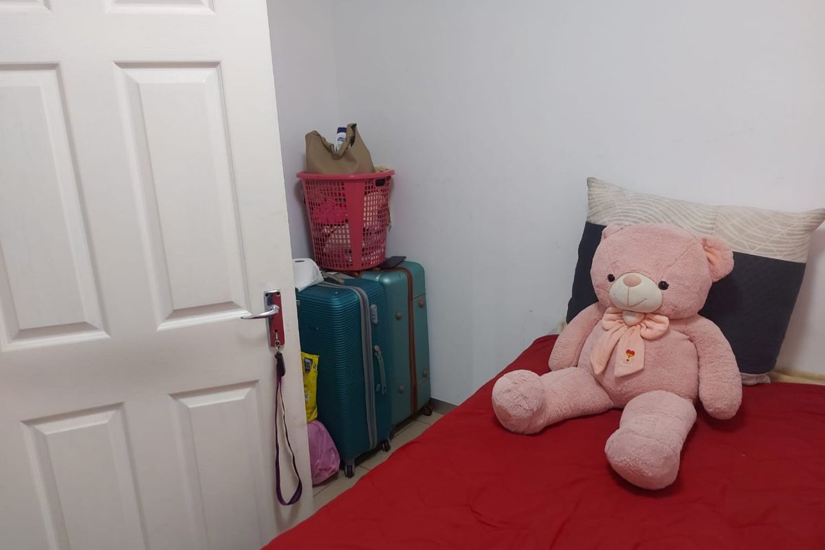 A simple bedroom interior featuring a standard panel door and basic finishes, suitable for personalization or staging.