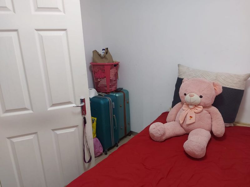 A simple bedroom interior featuring a standard panel door and basic finishes, suitable for personalization or staging.