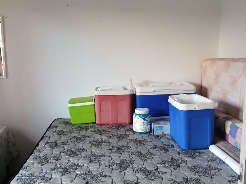 A bedroom space featuring plain walls and a mattress, suitable for renovation or staging to enhance the room's appeal.