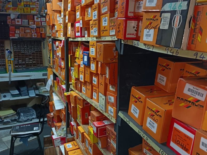 A commercial storage area featuring extensive metal shelving units organized with inventory boxes for efficient stock management.