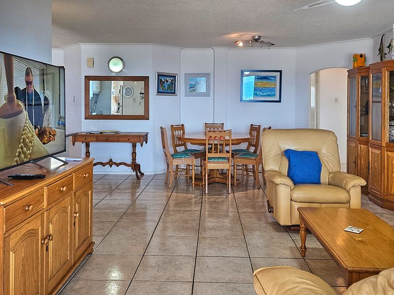 Spacious open-plan living and dining area featuring neutral tiled flooring and coved ceilings, offering a versatile layout for comfortable daily living.