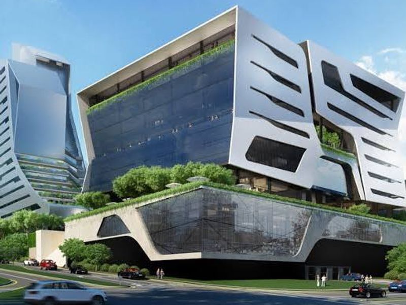 Modern commercial office building featuring a striking contemporary architectural design with extensive glass facades and integrated multi-level green terraces.
