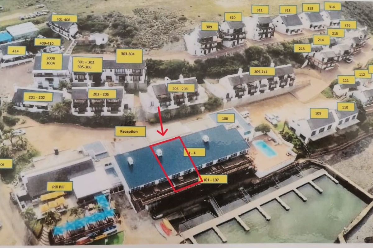 Aerial view of a coastal resort complex featuring multiple residential units, a swimming pool, and a jetty, with unit numbering overlays.