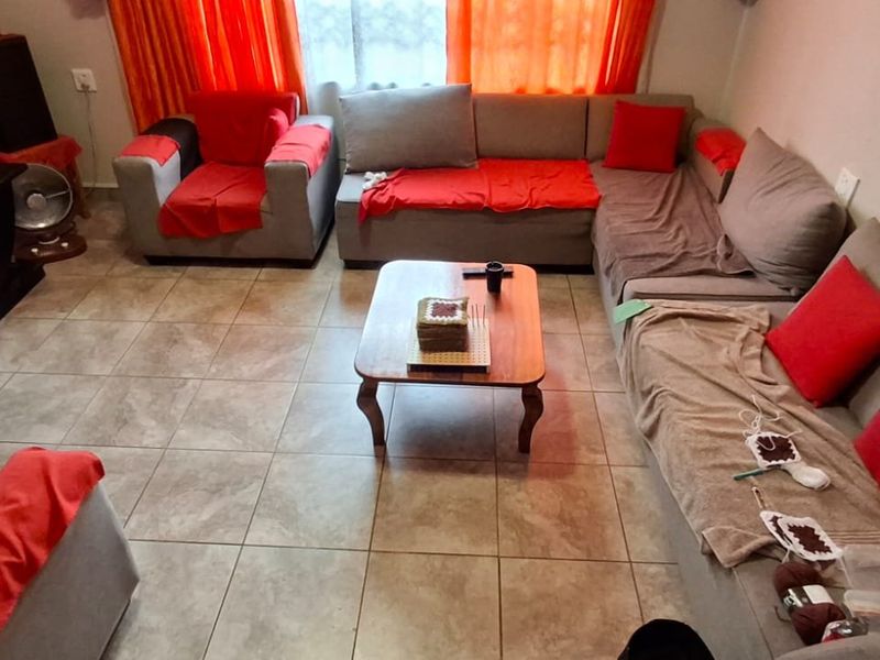 A comfortable living room featuring neutral tiled flooring, providing a functional and well-utilized space for relaxation.
