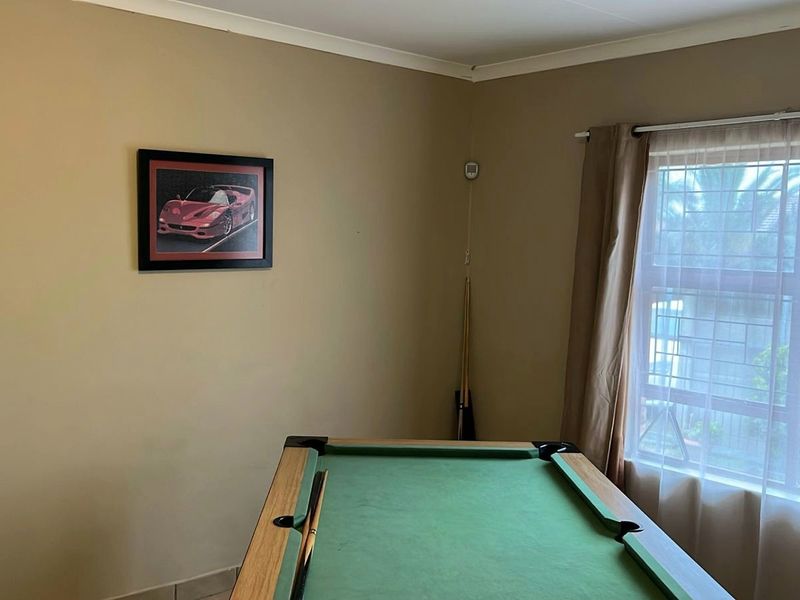 A multi-purpose room featuring neutral wall finishes and a window with natural light, suitable for a hobby room or home office.