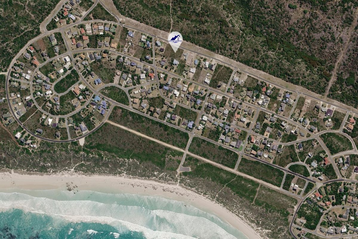 Aerial view of a coastal residential estate showing the layout of properties, road infrastructure, and proximity to the beach.
