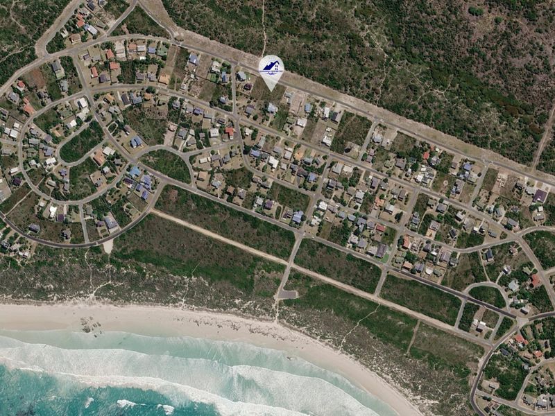 Aerial view of a coastal residential estate showing the layout of properties, road infrastructure, and proximity to the beach.