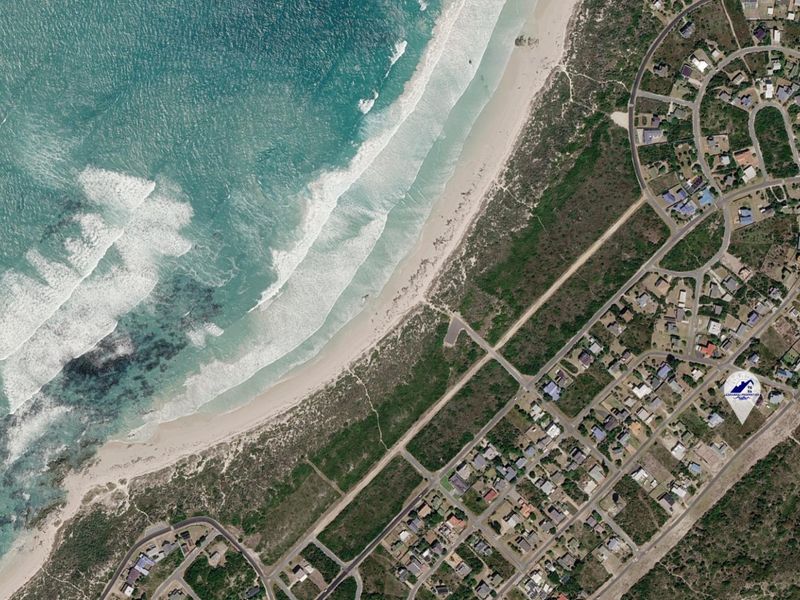 Aerial view of a coastal residential area showing proximity to the beach and surrounding neighborhood infrastructure.