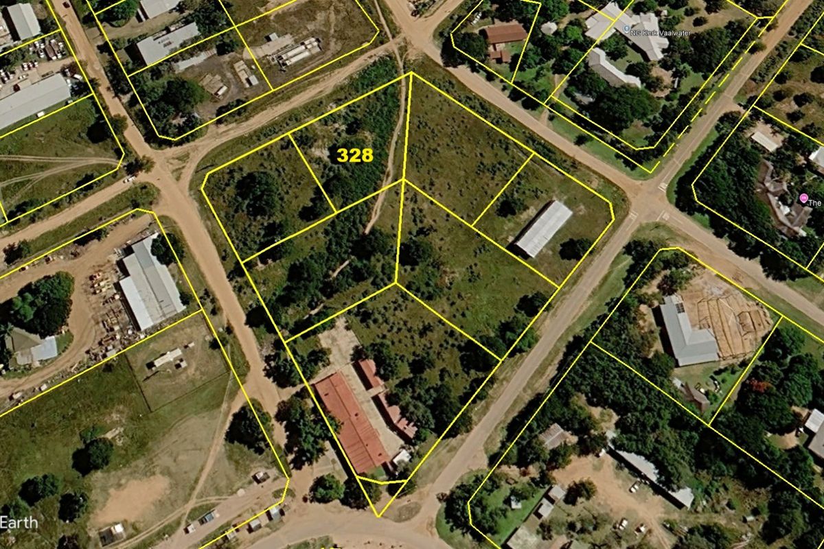 Aerial view of a vacant residential land plot with clearly marked boundaries in a suburban neighborhood setting.