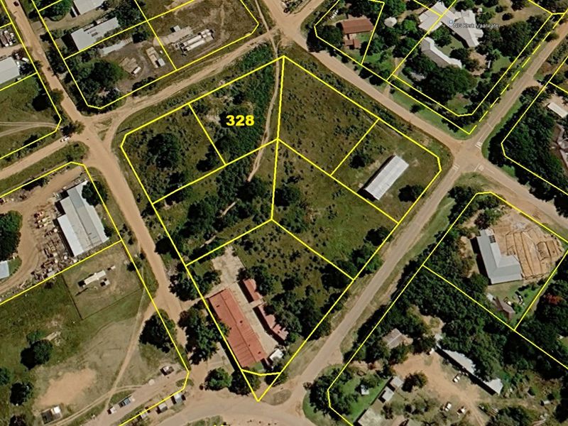 Aerial view of a vacant residential land plot with clearly marked boundaries in a suburban neighborhood setting.
