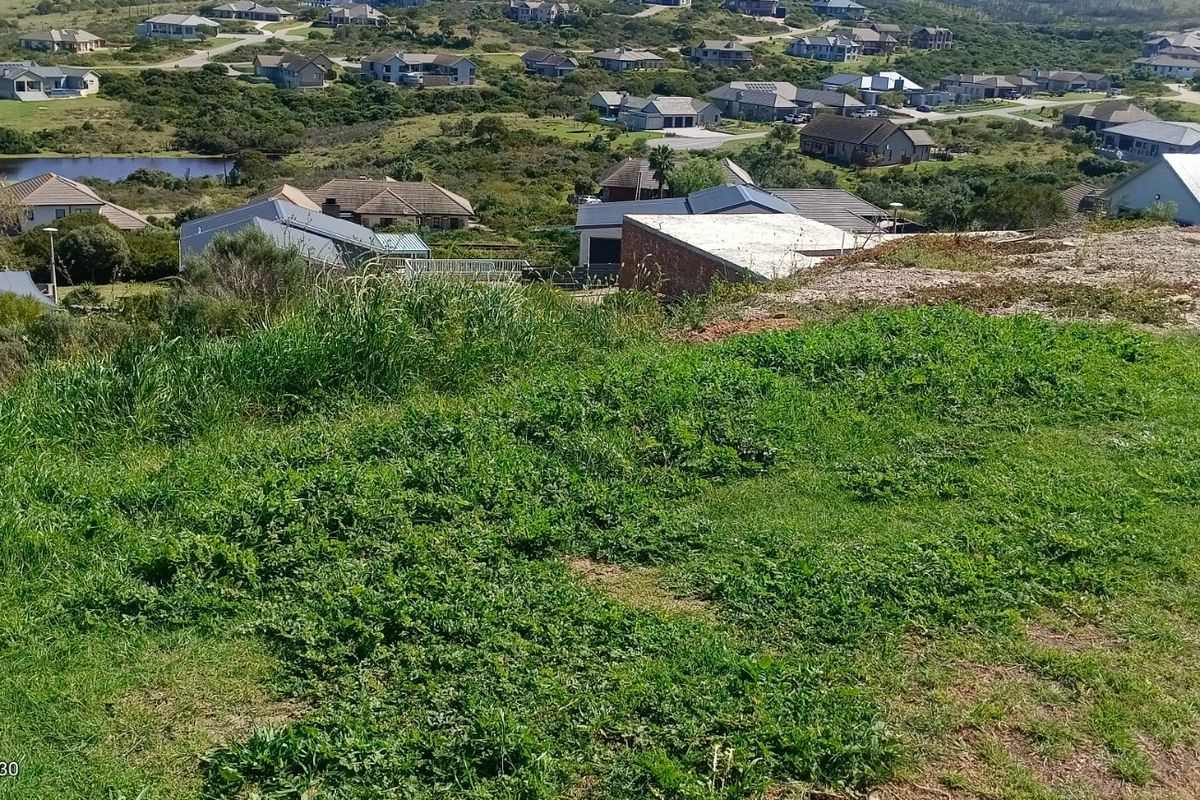 An elevated view overlooking a residential estate with surrounding landscape and housing developments.