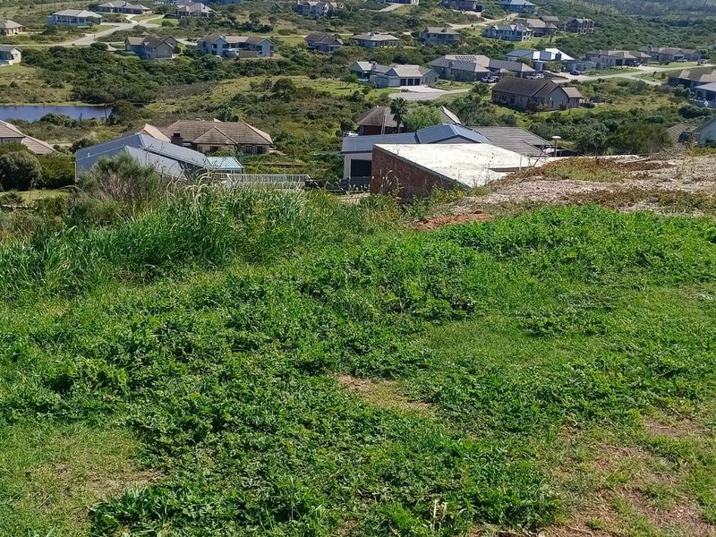 An elevated view overlooking a residential estate with surrounding landscape and housing developments.