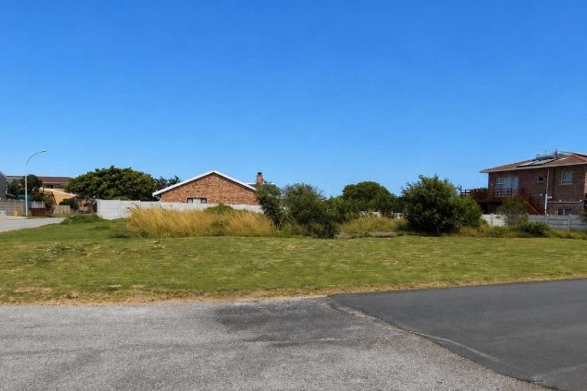 A vacant residential plot of land with street access, situated in a developed neighborhood with surrounding residential properties.