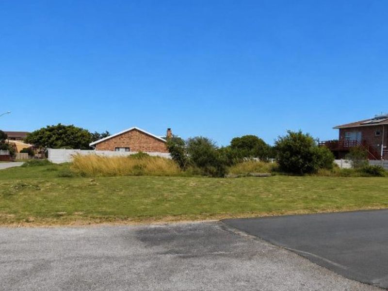 A vacant residential plot of land with street access, situated in a developed neighborhood with surrounding residential properties.