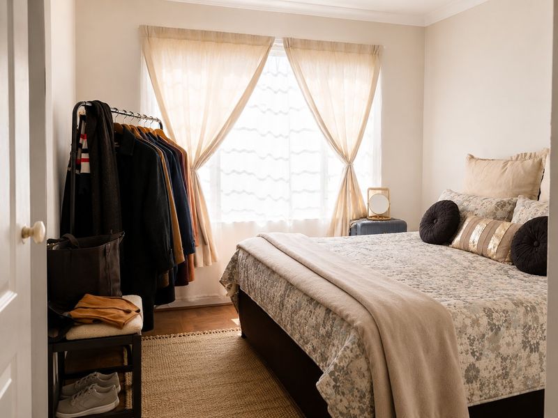 A well-lit bedroom featuring parquet flooring and classic coving, providing a comfortable and neutral space.