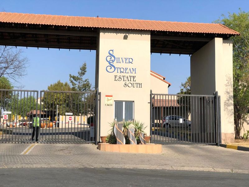 The main entrance gate and security checkpoint for Silver Stream Estate South, featuring a gated access point and guard house.