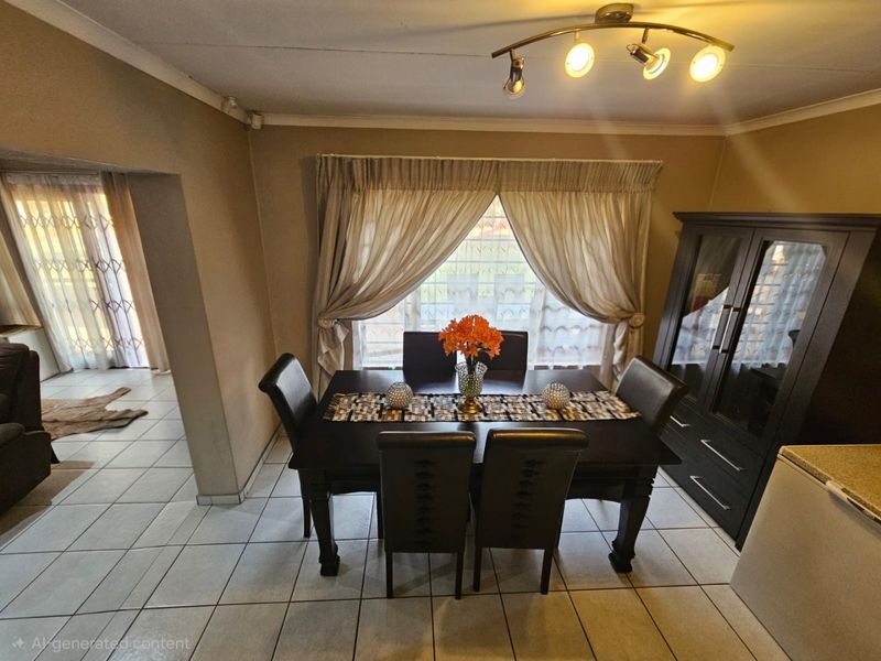 A dining area featuring ceramic floor tiles, ceiling-mounted track lighting, and a view through to an adjacent space with a security gate.