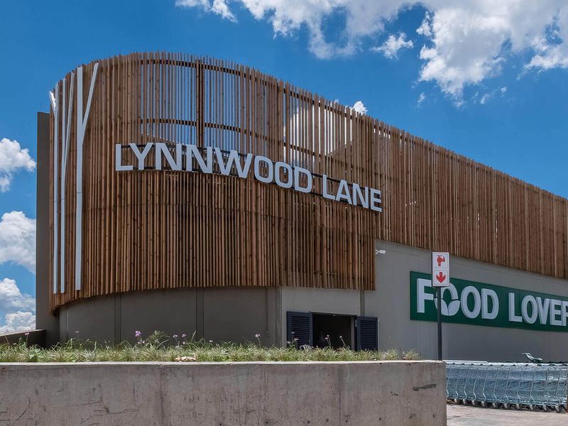 Exterior view of the Lynnwood Lane commercial building featuring a modern timber slat facade and prominent signage.