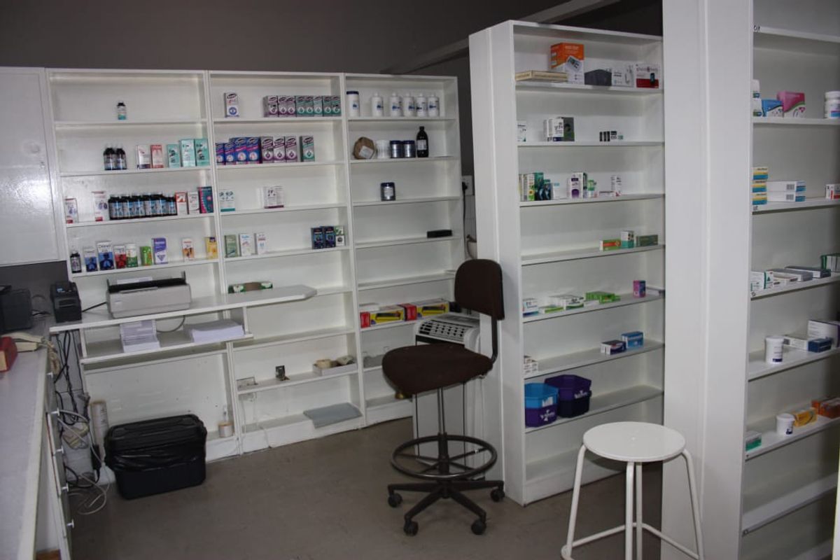 A functional commercial utility or storage space featuring extensive built-in white shelving units for organized inventory management.