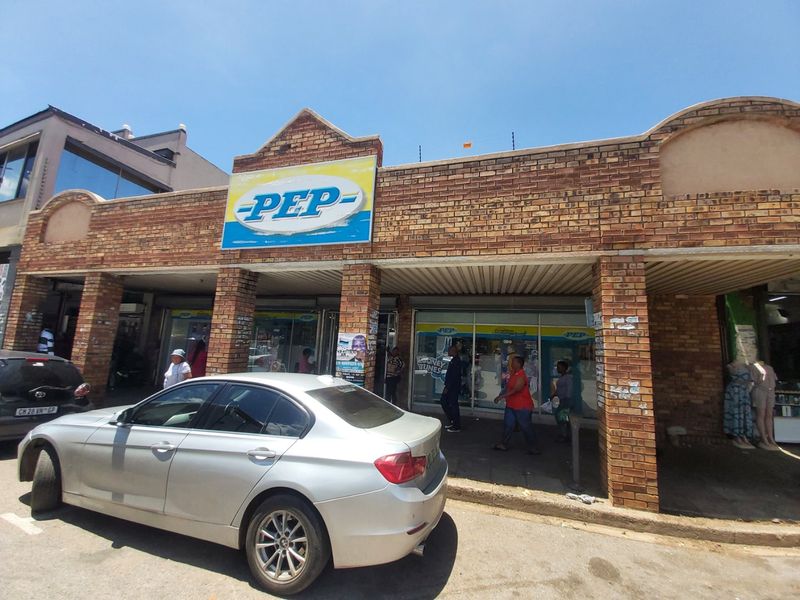 Commercial storefront featuring a face brick facade, brick pillars, and large glass display windows, providing high visibility for retail operations.