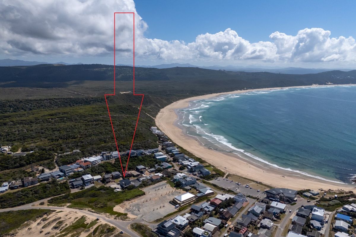 Aerial view showing the property's prime coastal location near the beach and surrounding residential estate.