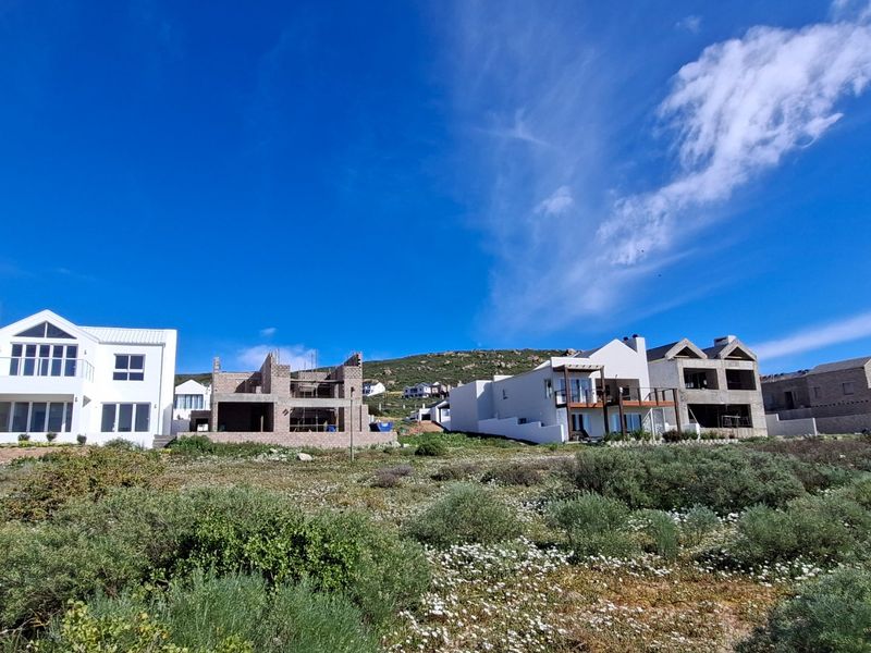 A view of a residential development area featuring a mix of completed homes and properties currently under construction.