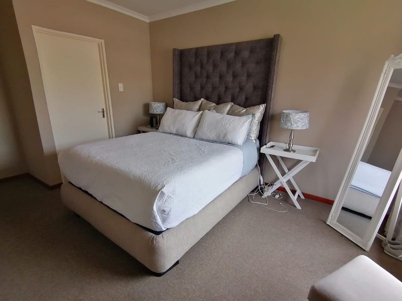 A carpeted bedroom featuring neutral wall tones and a coved ceiling, providing a comfortable and functional sleeping space.