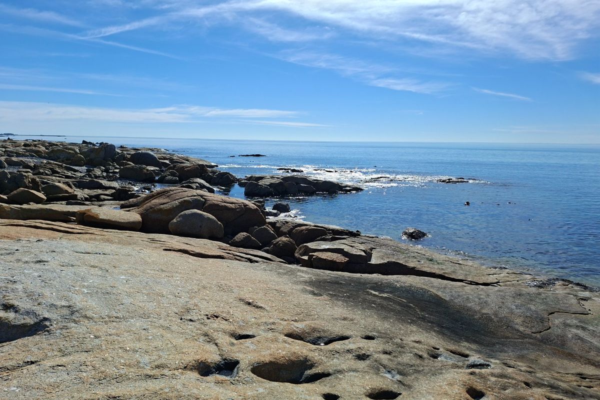 A scenic view of the rocky coastline and ocean, highlighting the natural landscape of the vacant residential property.