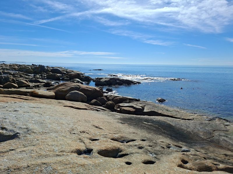 A scenic view of the rocky coastline and ocean, highlighting the natural landscape of the vacant residential property.