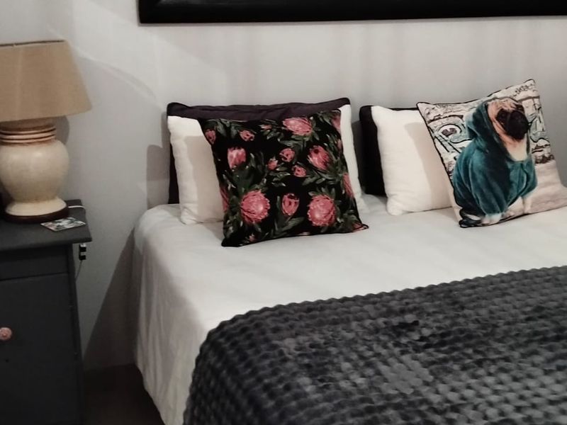 A standard bedroom interior featuring neutral wall finishes and space for a double bed and bedside storage.