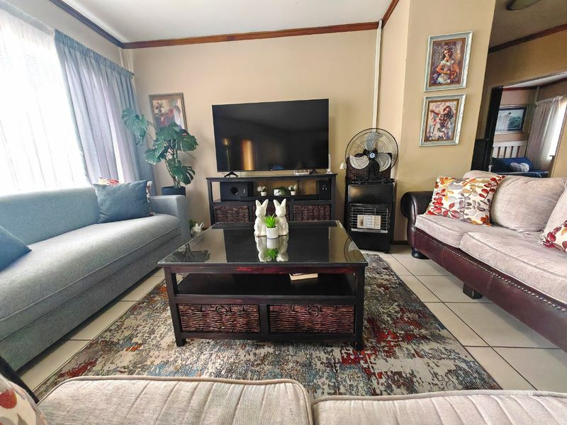 A comfortable living room featuring tiled flooring and neutral wall tones, providing a functional space for relaxation and entertainment.