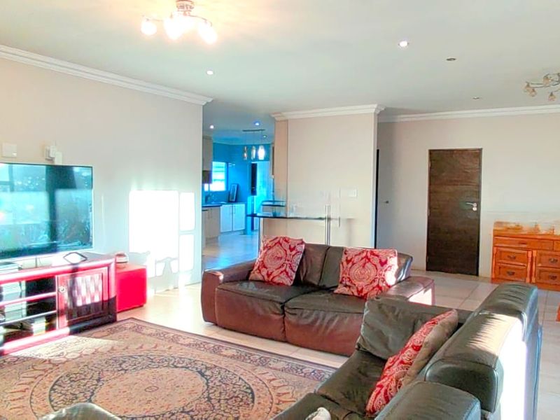 Spacious open-plan living and dining area featuring tiled flooring, recessed lighting, and neutral wall finishes, providing a versatile layout for family living.